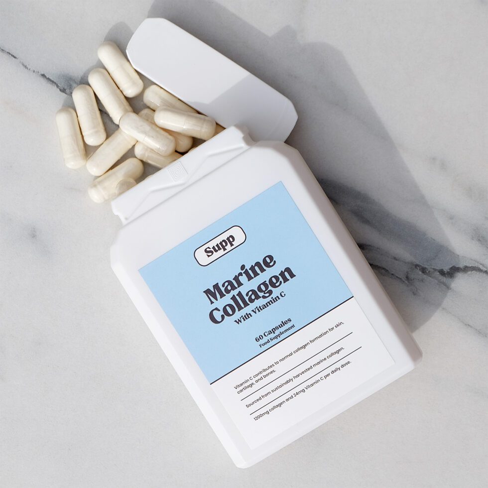 Supp Marine Collagen spills onto a marble table.
