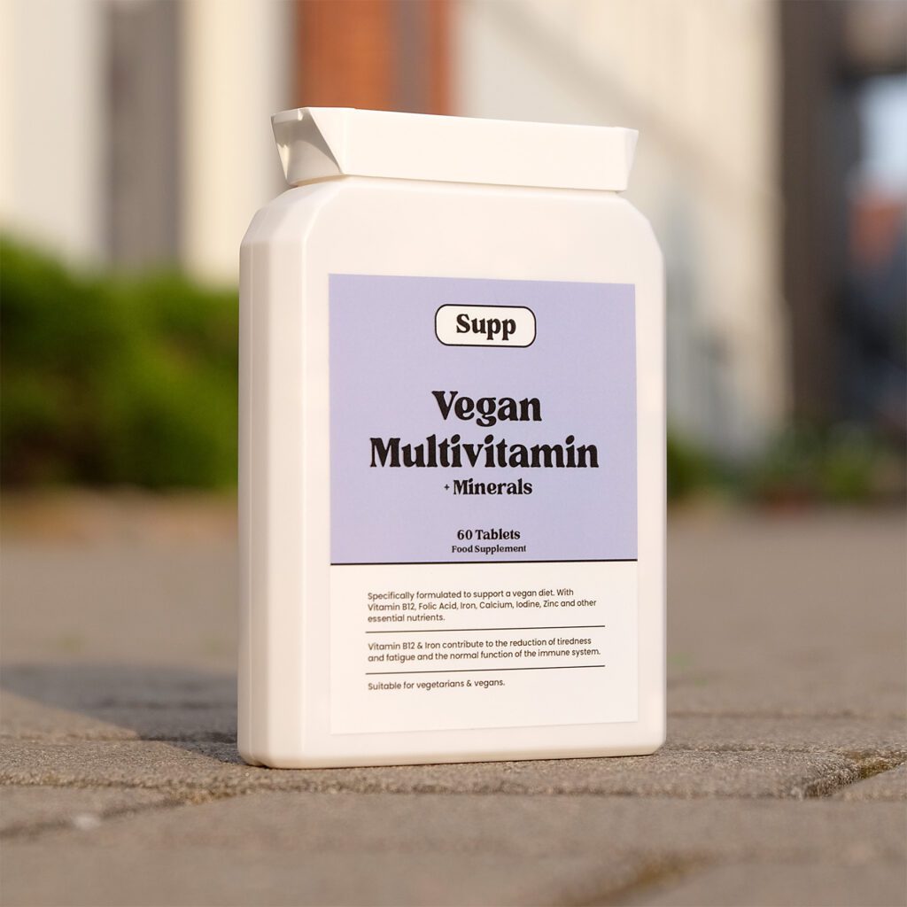 Supp Vegan Multivitamin stood in the sunset light.