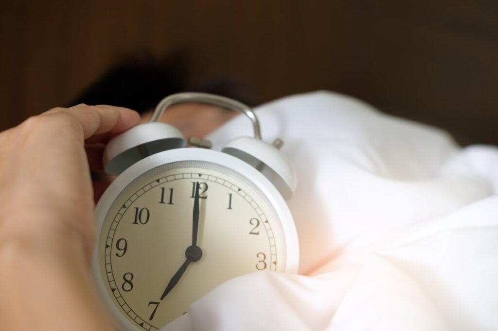 an alarm clock white in bedding
