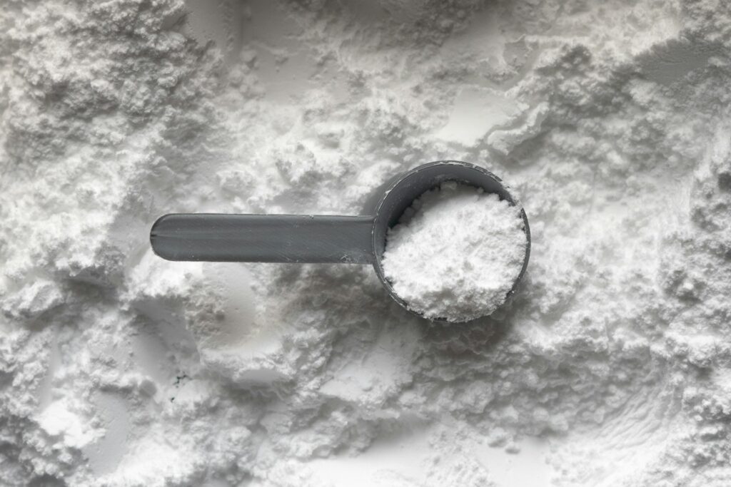 scoop of white creatine powder