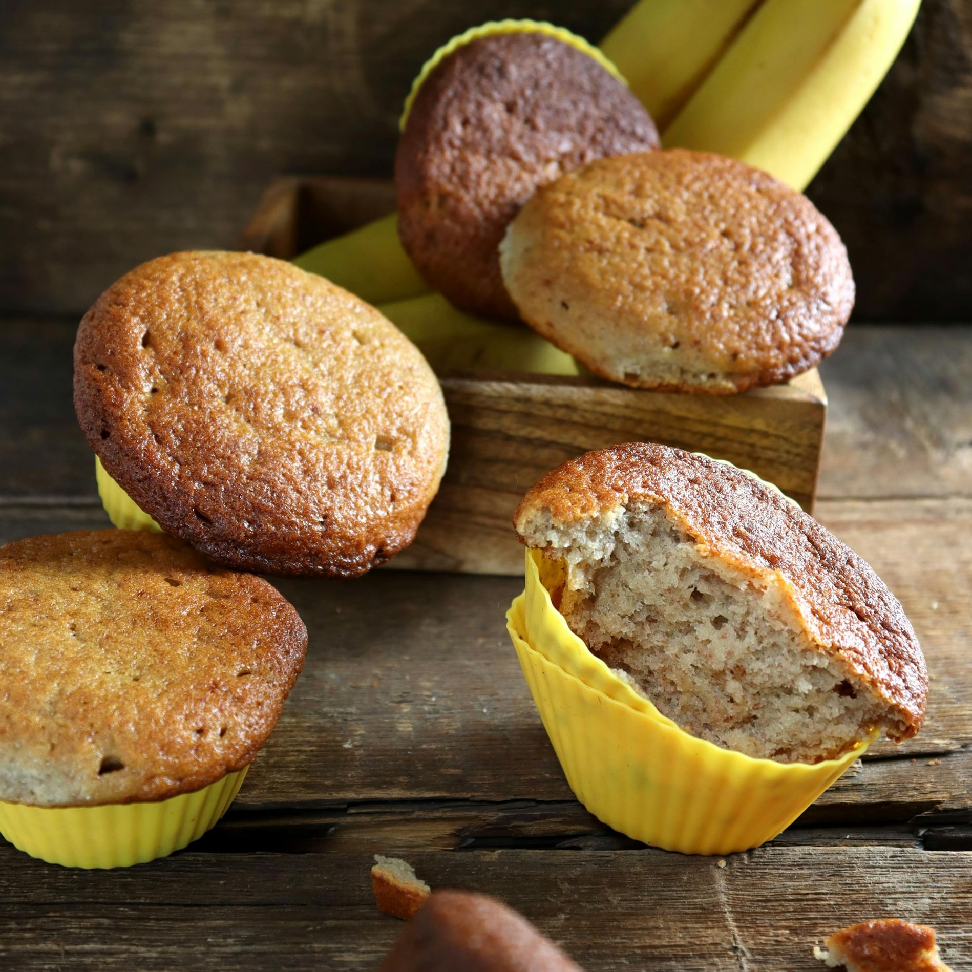 Banana oat muffins in a rustic setting.
