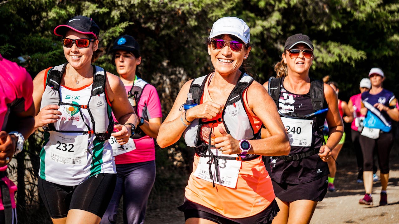 a smiling woman running a marathon