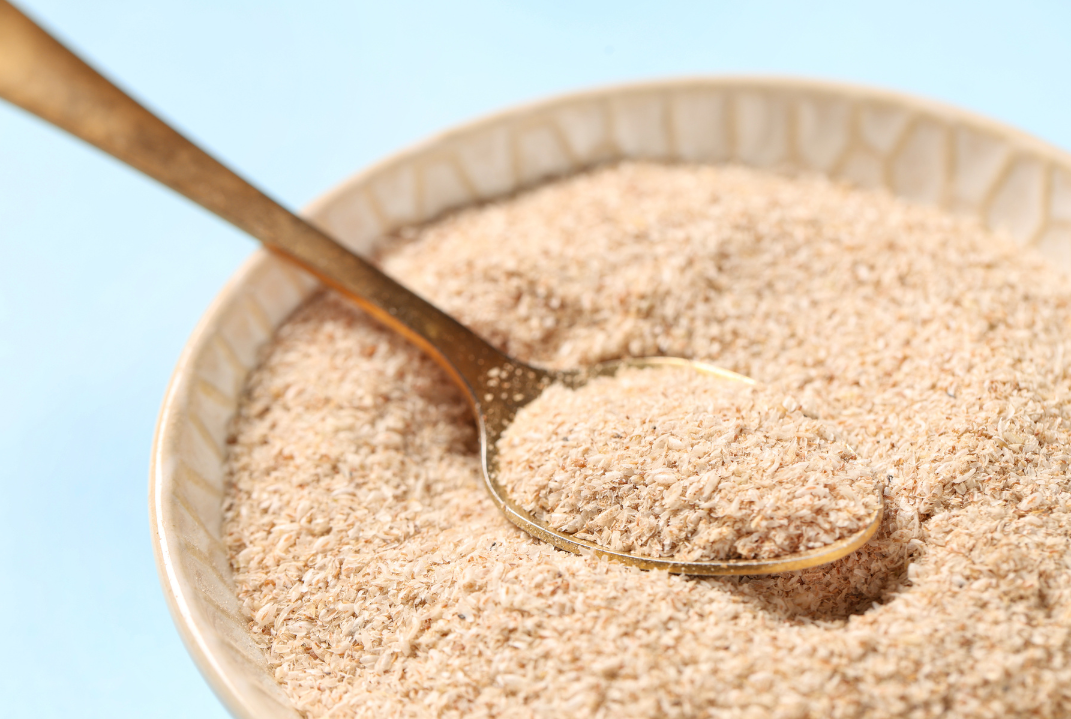 psyllium husk Bowl of Psyllium Husk powder on a blue background.