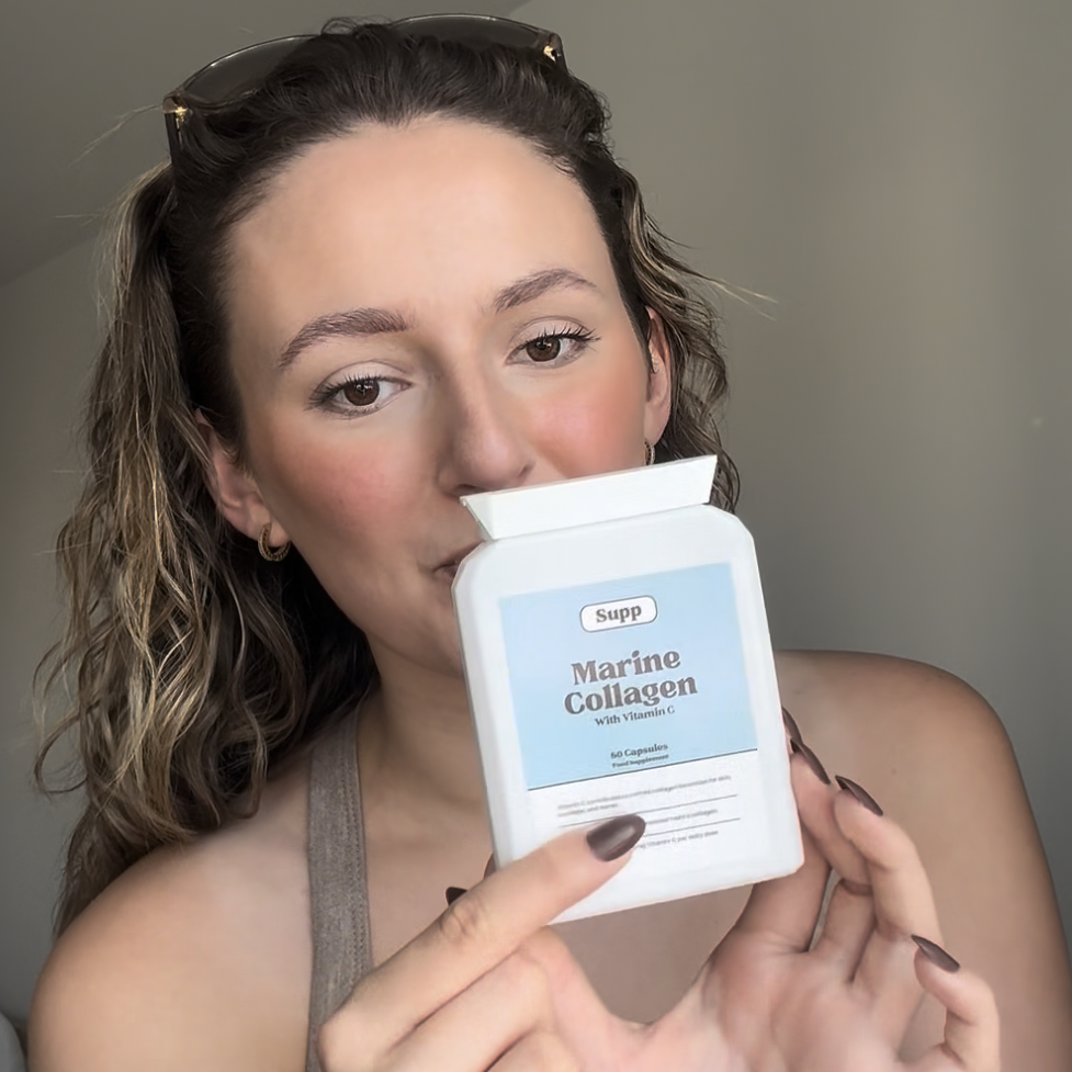 Georgia holds up a bottle Supp Marine Collagen.